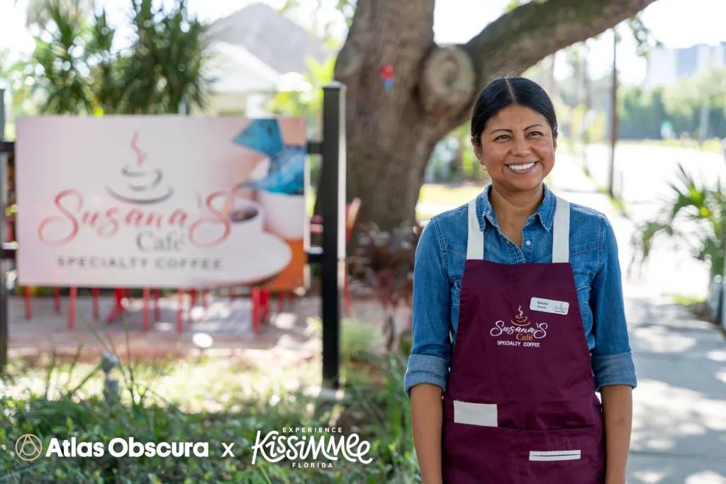 Woman stood in front of sign that says Susanas Cafe
