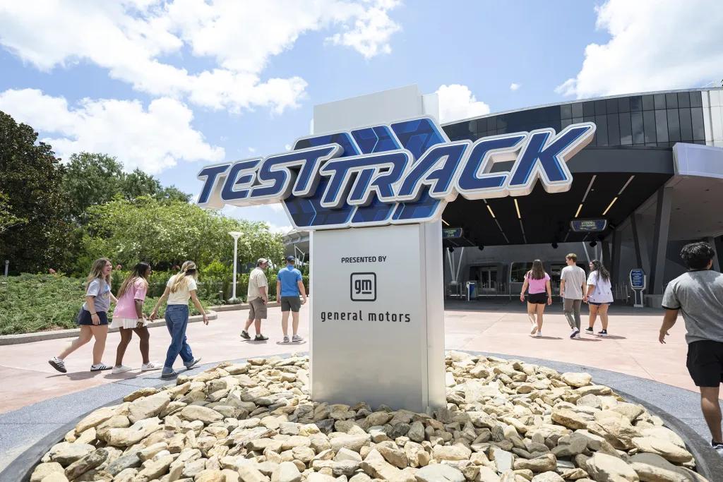 Test Track ride sign outside of a modern building.