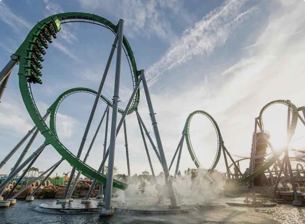 The Incredible Hulk Coaster at Universal Islands of Adventure looping over water with mist effects.