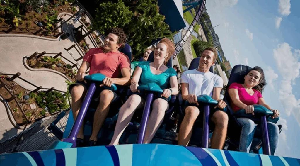 Thrilled riders smiling as they experience the intense drops and speeds of the Mako hypercoaster at SeaWorld Orlando.