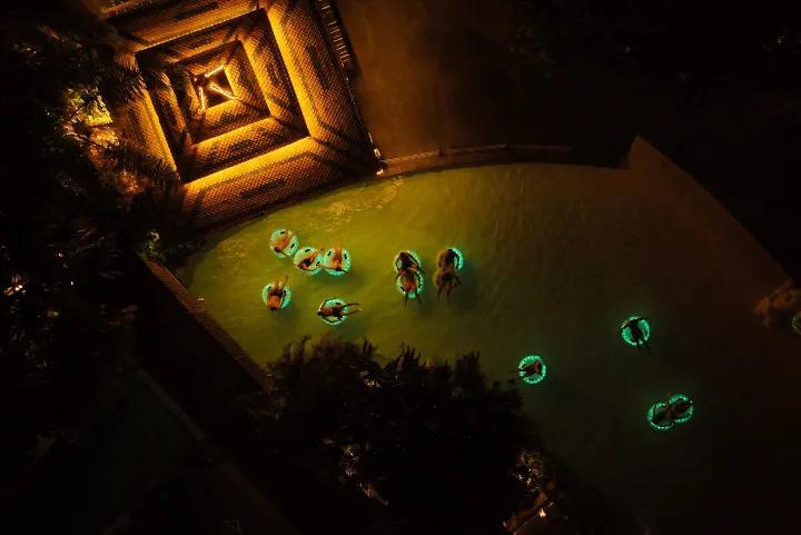 A group of people in inflatable rings at Siam Park during Siam Night