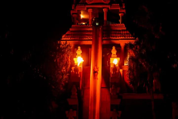 A man sliding down Tower of Power ride at Siam Park at night