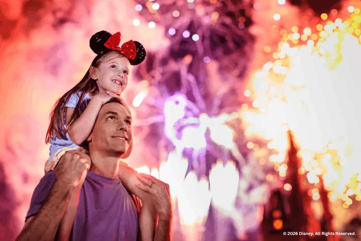 A father and daughter enjoying fireworks at Magic Kingdom Park
