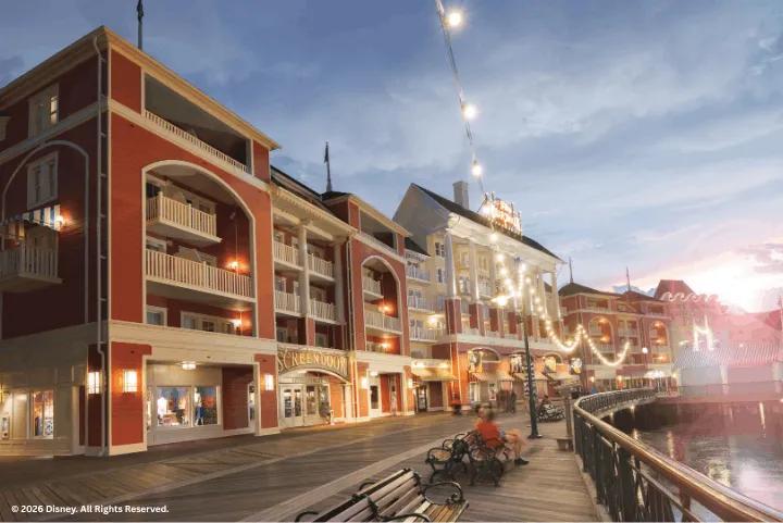 Disney's BoardWalk at dusk, with string lights, shops, and lakeside benches