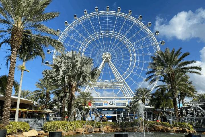 The Wheel at ICON Park in Orlando, surrounded by palm trees and fountains