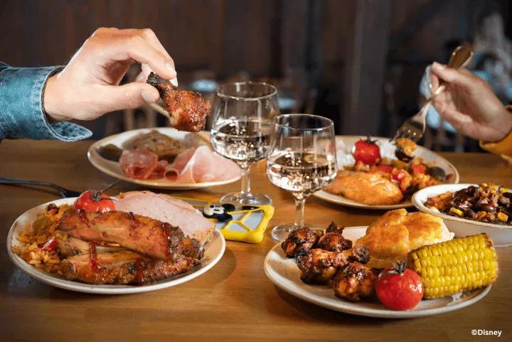 Table spread of barbecue chicken, ribs, corn, and biscuits at Billy Bob's Country Western Saloon