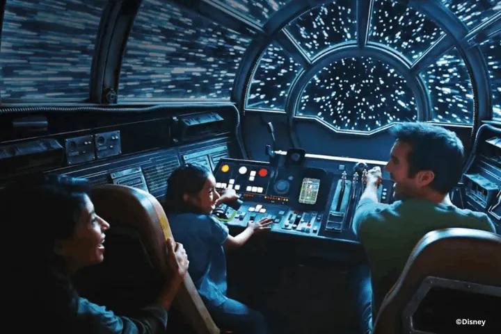 Guests piloting the Millennium Falcon through hyperspace inside the cockpit of Millennium Falcon: Smugglers Run