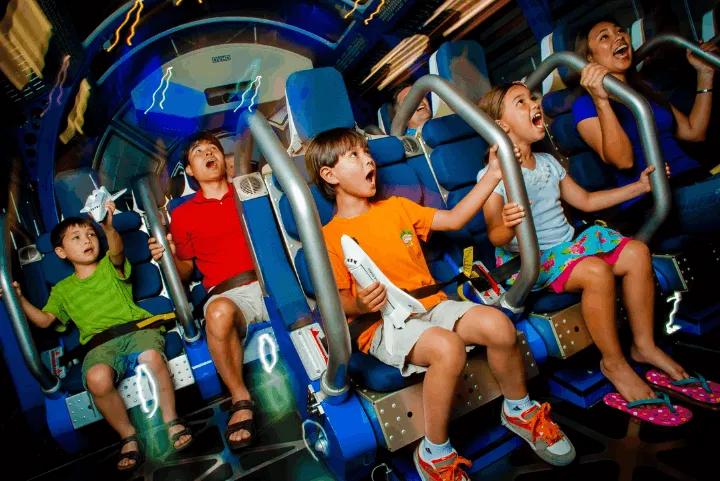 Guests experiencing motion seats inside the Shuttle Launch Experience simulator