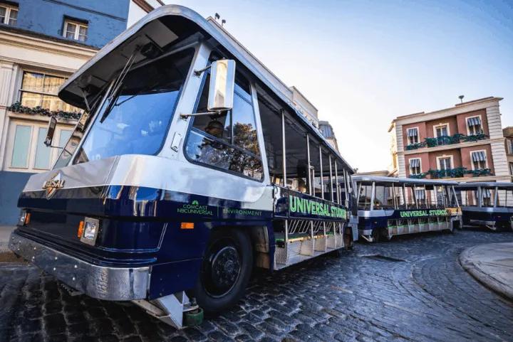 Universal Studios trams parked on a cobblestone street backlot
