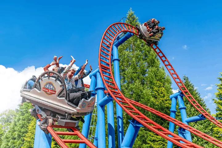 Riders spinning through a loop on Spinball Whizzer's red track at Alton Towers