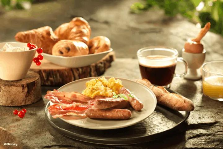 Breakfast spread with sausages, eggs, bacon, pastries, and coffee at Disney Sequoia Lodge