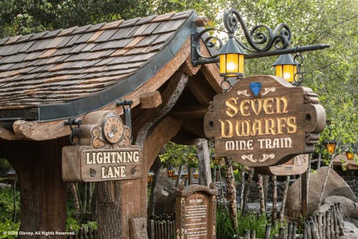 Wooden signage for the Lightning Lane entrance at Seven Dwarfs Mine Train in Magic Kingdom Park