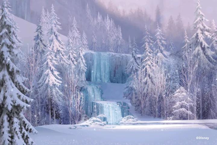 Snow-covered pine trees surrounding a frozen, cascading waterfall in a winter landscape