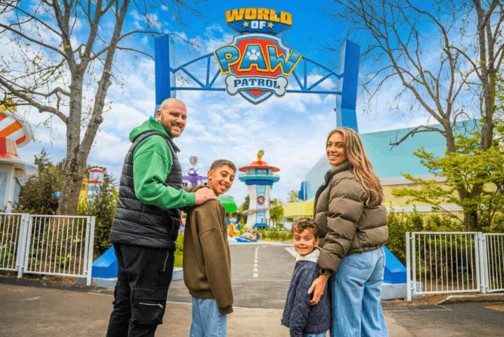A family posing at the entrance to the World of PAW Patrol at Chessington World of Adventures