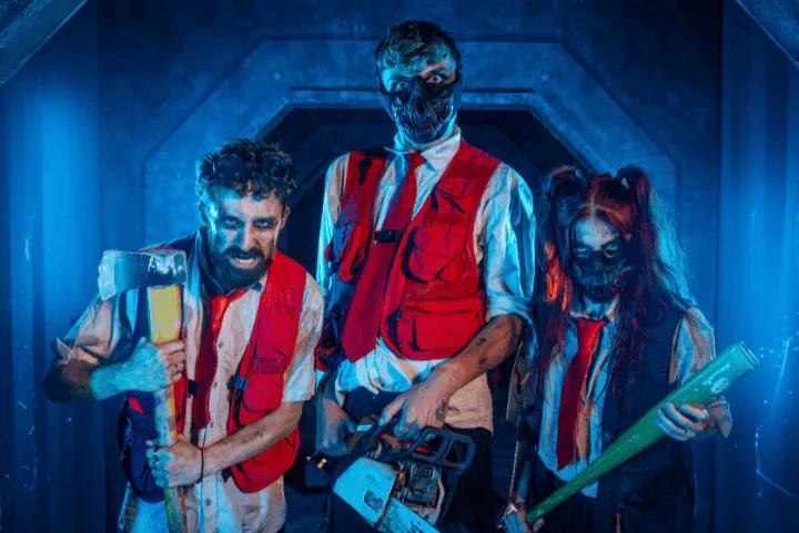 Three intimidating actors holding weapons in a blue-lit corridor