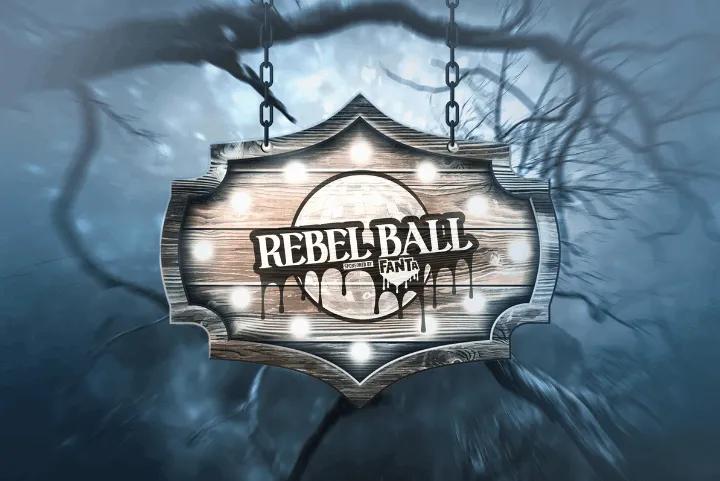 An illuminated wooden sign for Rebel Ball hanging against a dark, misty background with bare branches