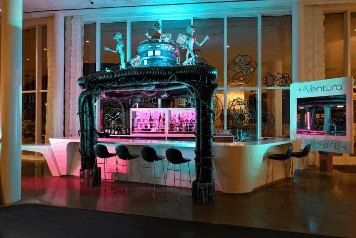 Alien-themed barVentura at Universal Aventura Hotel featuring alien figures atop a dark arch with neon lighting