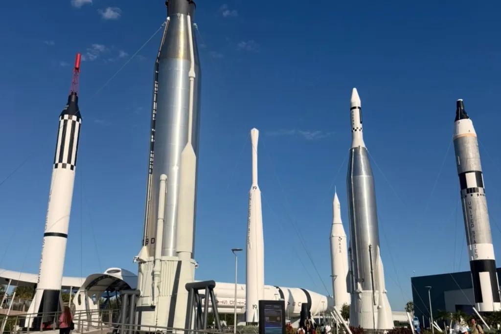 Large models of rockets towering over pathway.