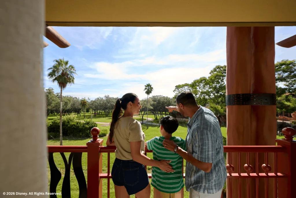A family standing on a balcony looking out over the savanna at Disney's Animal Kingdom Lodge