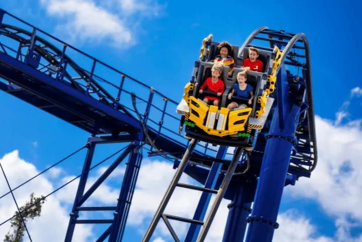 Four children riding The Great Lego Race roller coaster