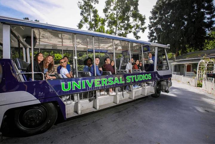 Guests smiling and riding the electric tram on the Universal Studios Studio Tour