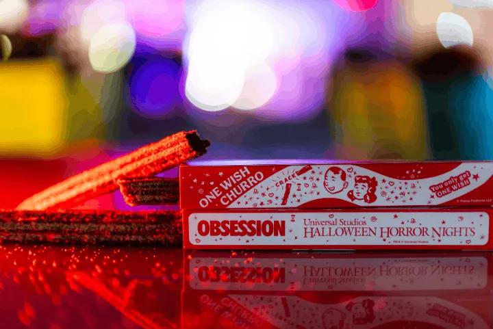 Red churros resting next to boxes labeled One Wish Churro and Halloween Horror Nights