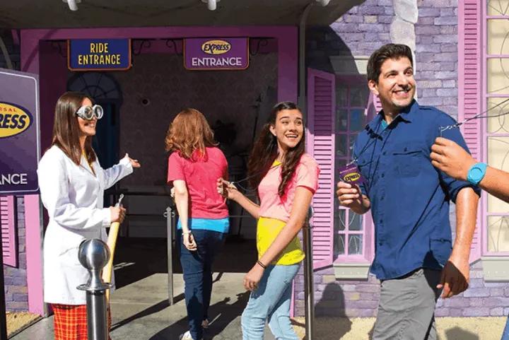 Guests showing Express Passes to an attendant at a ride entrance