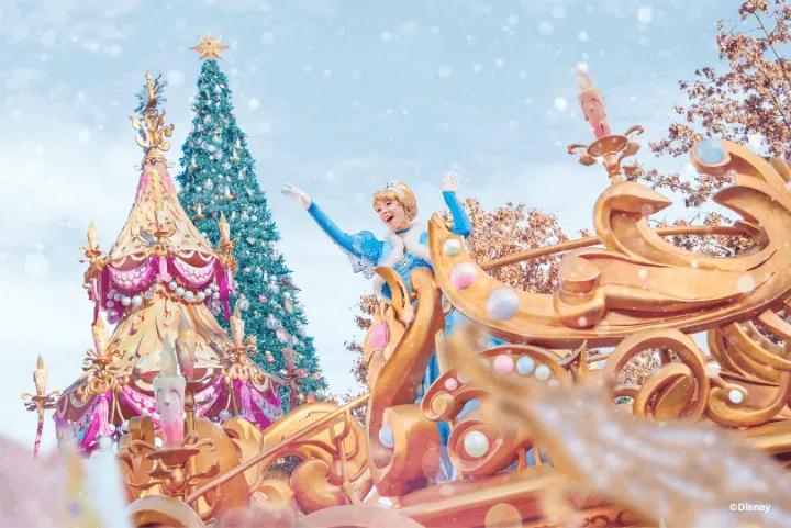 Cinderella waving from a golden float during a snowy Christmas parade