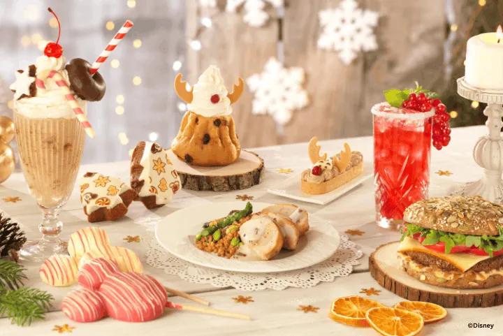 A variety of festive holiday-themed meals, desserts, and drinks displayed on a decorated table