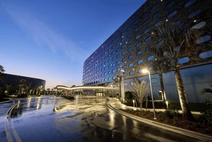 The illuminated exterior and driveway of the Universal Terra Luna Resort at dusk