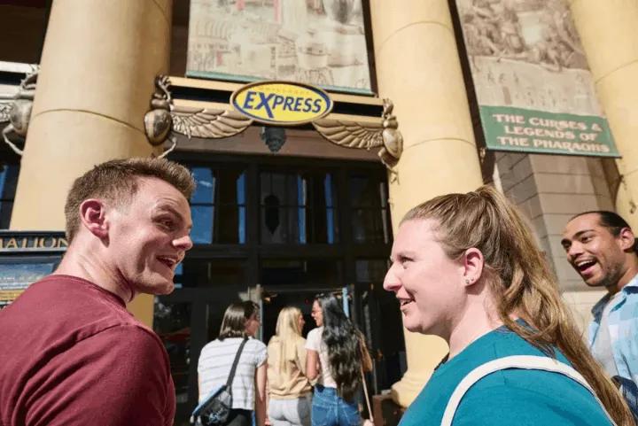 A couple standing outside the Express lane at a Universal Orlando park