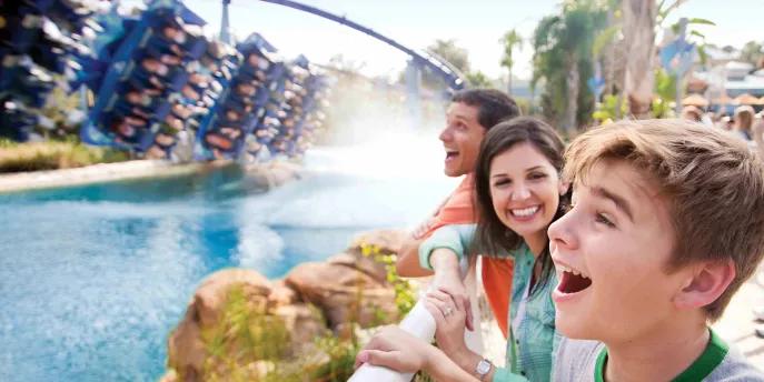 Boy watching guests riding Manta rollercoaster at SeaWorld Orlando