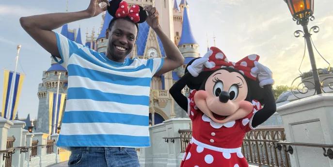 Best Day Ever! A man wearing Minnie ears standing with Minnie Mouse in front of Cinderella Castle
