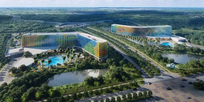 Universal Stella Nova and Terra Luna Resorts Concept art of two curve-shaped hotels next to each other with multi-coloured panelling
