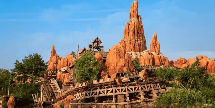 Looking over a river towards Big Thunder Mountain roller coaster