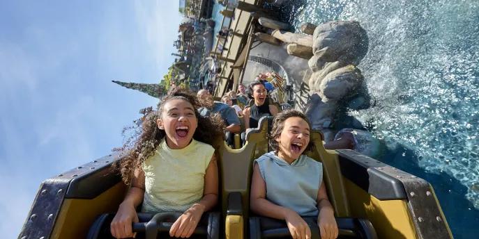Hiccup's Wing Gliders at Universal Epic Universe Two kids riding a rollercoaster over water