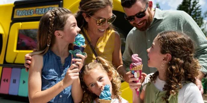 A family enjoying treats at Universal Orlando Resort, illustrating the ease of accessing resort activities and major attractions in Orlando using car-free transport options like shuttles and rideshares.