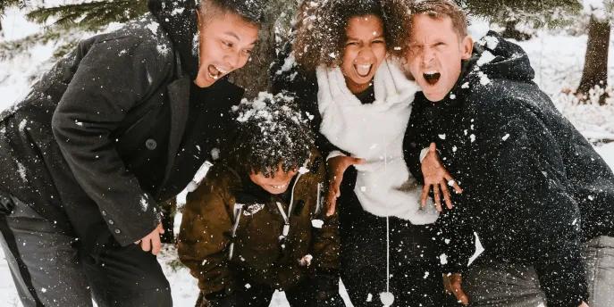 A happy family playing in the snow during a winter holiday