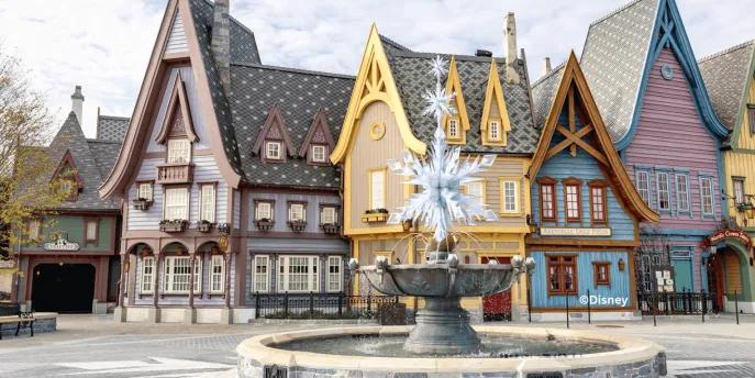 Arendelle-style buildings surround a crystalline snowflake fountain at Disneyland® Paris