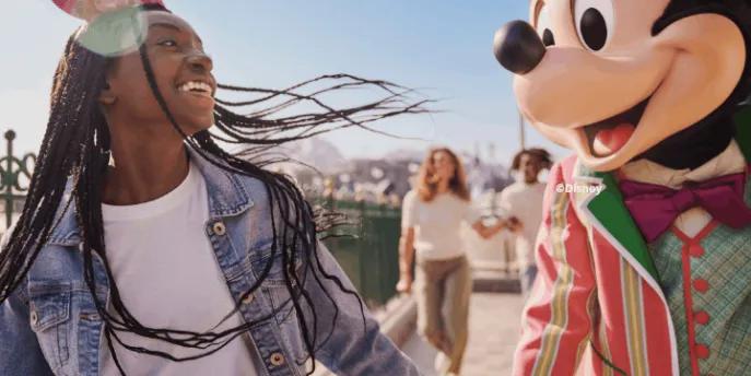 Guest with Mickey Mouse at Disney Adventure World