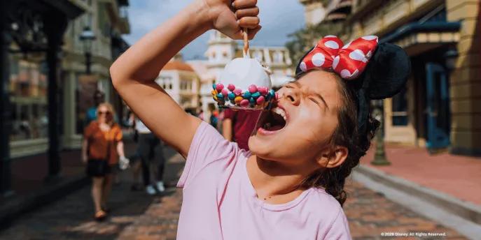 Guest on Main Street, U.S.A. eating a snack