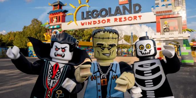Three costumed Lego Halloween characters standing in front of the Legoland Windsor Resort entrance