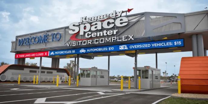 The parking toll booths and welcome sign at the entrance to the Kennedy Space Center Visitor Complex