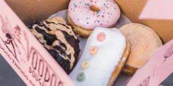 A box of iced ring and filled doughnuts from Voodoo Doughnuts