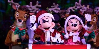 Mickey and Minnie dressed as Mr and Mrs Claus riding in a sleigh