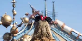 A girl wearing Minnie ears standing with her back to the camera, looking at Hyperspace Mountain