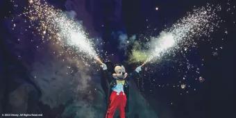 Mickey Mouse in Fantasmic with fireworks coming from his outstretched hands