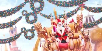 Santa Claus on a parade float being pulled by mechanical reindeer, with Mickey Mouse wreaths and Sleeping Beauty Castle in the background