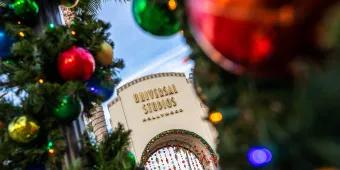 The Universal Studios Hollywood entrance decorated for Christmas with garlands and baubles