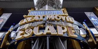 Universal's Great Movie Escape An art deco style sign on the outside of a building, which says Universal's Great Movie Escape